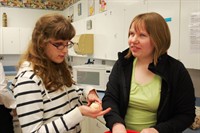 Two students working in the kitchen together
